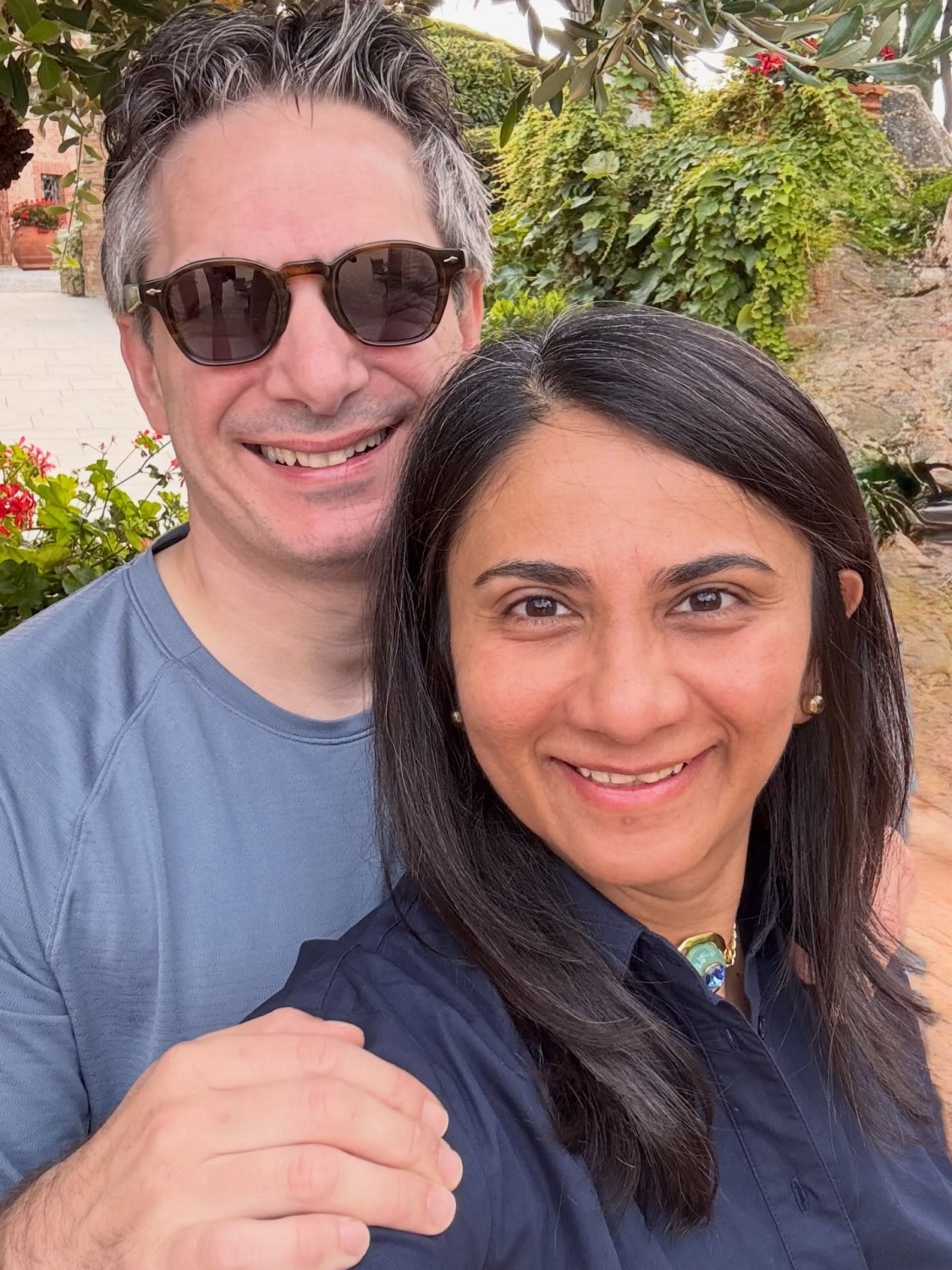 Riccardo and Divya smiling outdoors